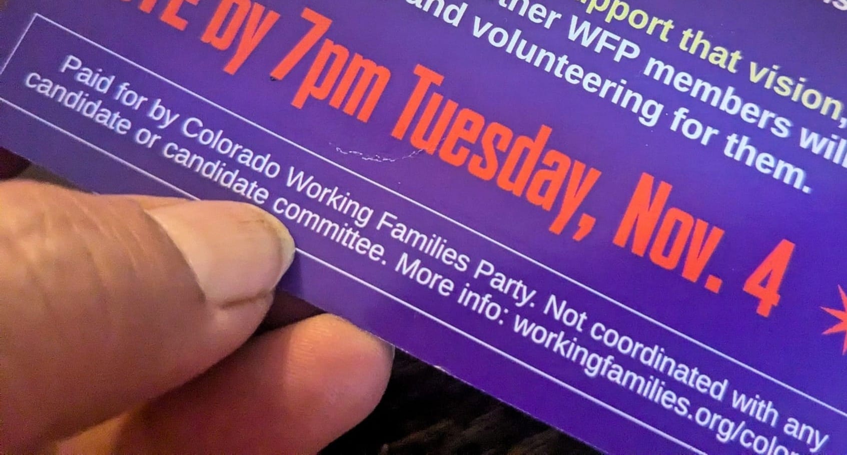 Lucy Molina holding an IEC flyer